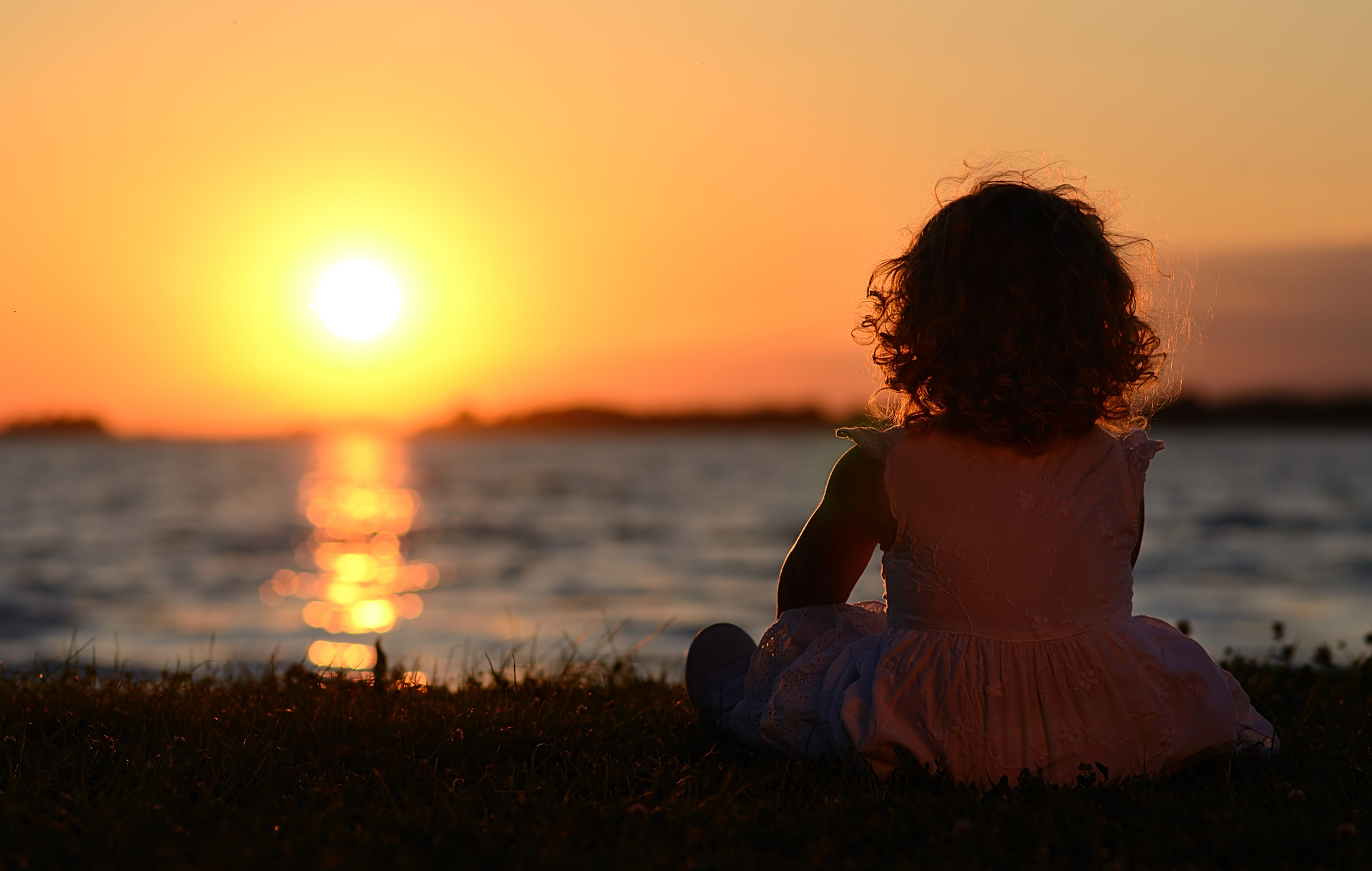 Relaxing young child in sunset